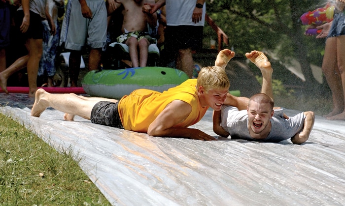 kids going down a water slide at family retreat
