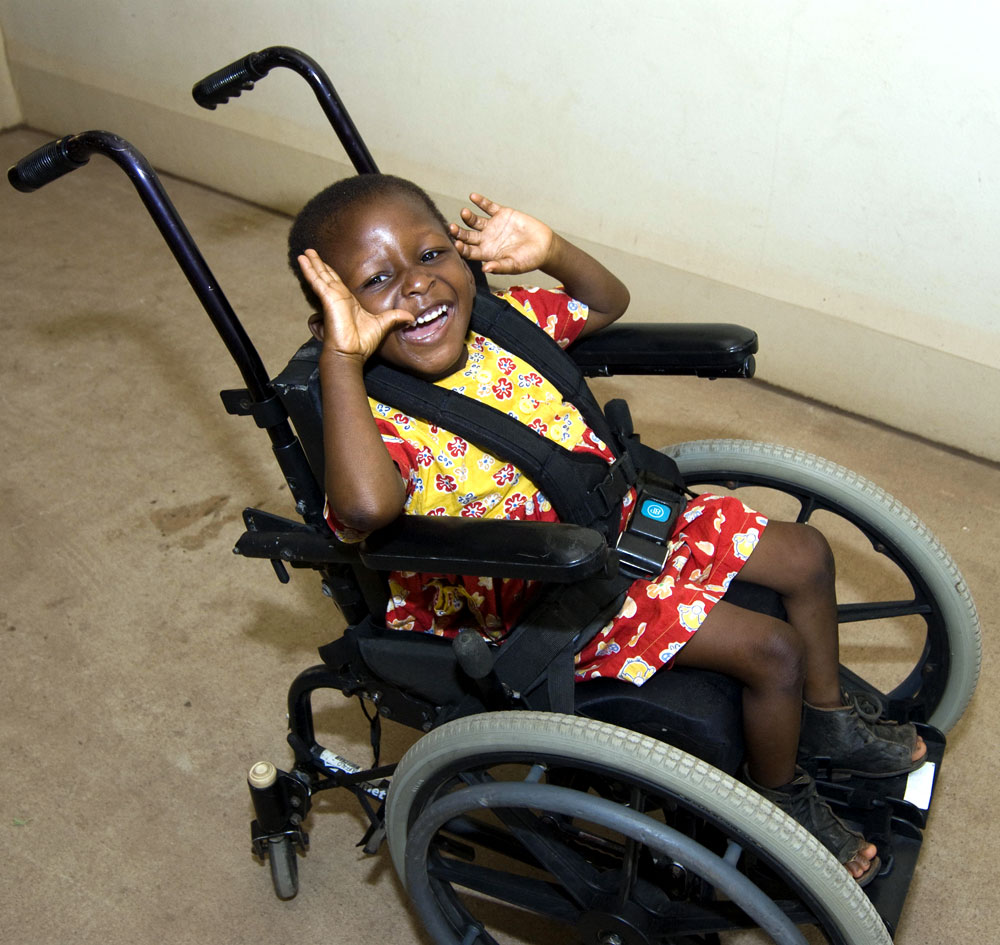 Girl from Ghana Girl from Ghana in wheelchair with big smile on her face and arms raise high