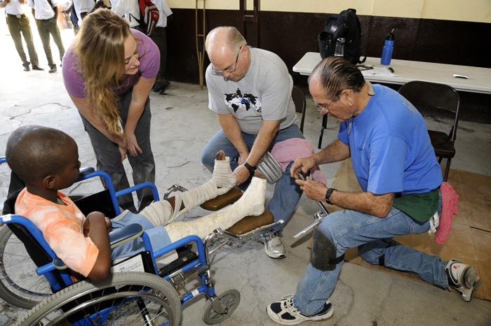 Doug Mazza - Haiti WFTW Doug Mazza helping fit a boy with a wheelchair