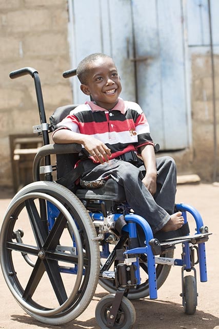 Hope Overflowing: Delivering 100,000 Wheelchairs by 2020 Ebenezer receiving a wheelchair from Wheels for the World in Ghana