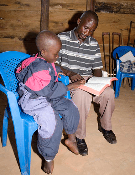 Thank you for Giving the Greatest Gift — God’s Word! Father and son reading their new Bible together