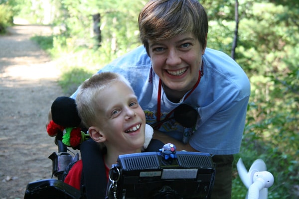 boy in wheelchair with a friend boy in wheelchair with a friend
