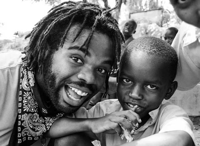 Bryan smiling with a child in Uganda Bryan smiling with a child in Uganda