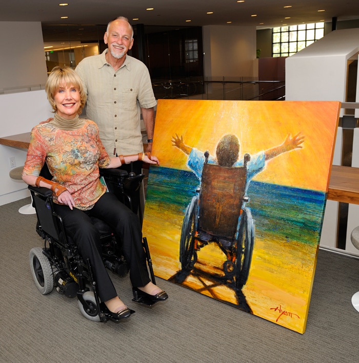 joni and matthew standing in front of his painting