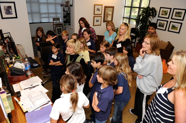 group of kids in joni's office watching her use her computer