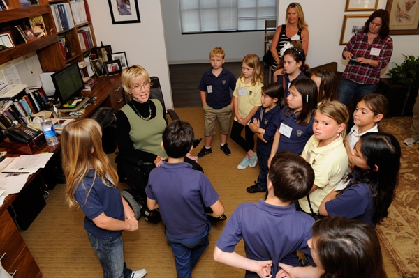 joni in her office speaking to a group of young kids