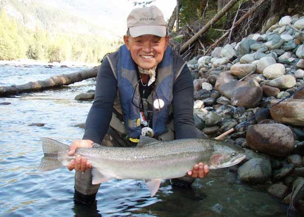 Ken holding a large fish that he caught fly-fishing