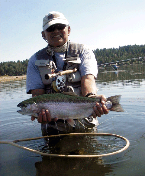 ken tada holding a fish he caught