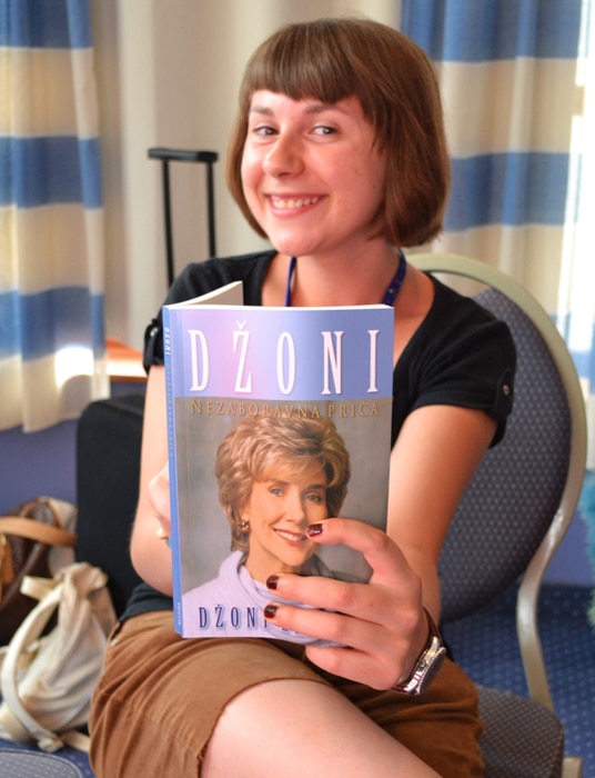 Woman holding Joni book in Serbian Woman holding Joni book in Serbian