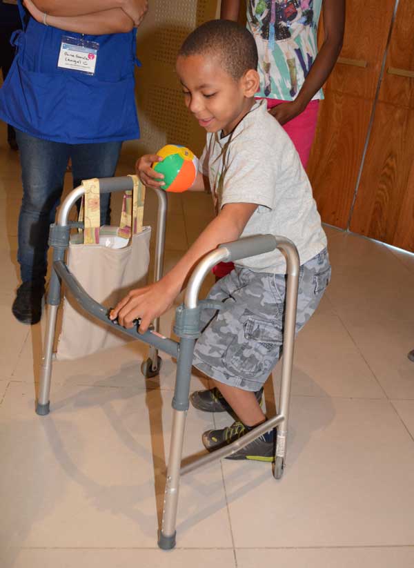 Boy with bag on his walker Boy with bag on his walker