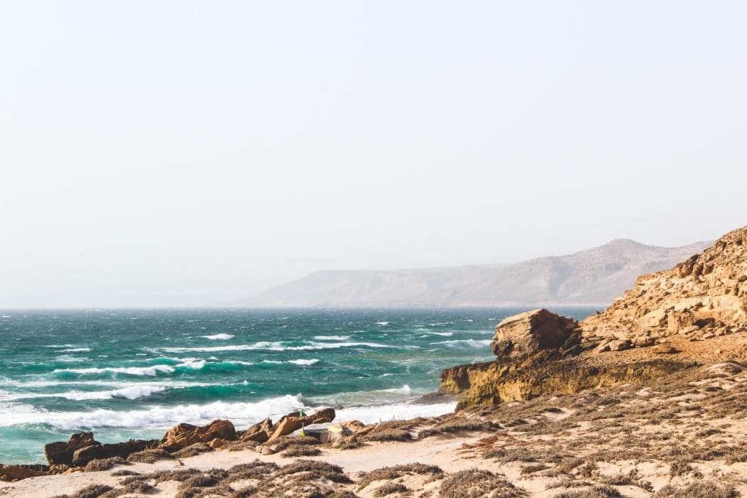 The coast featuring dramatic rocky shorelines, desert backdrops, and azure waters.