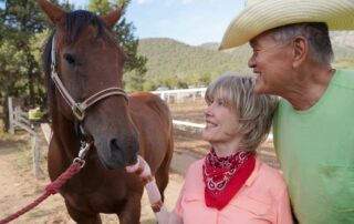 Joni and Ken petting a horse