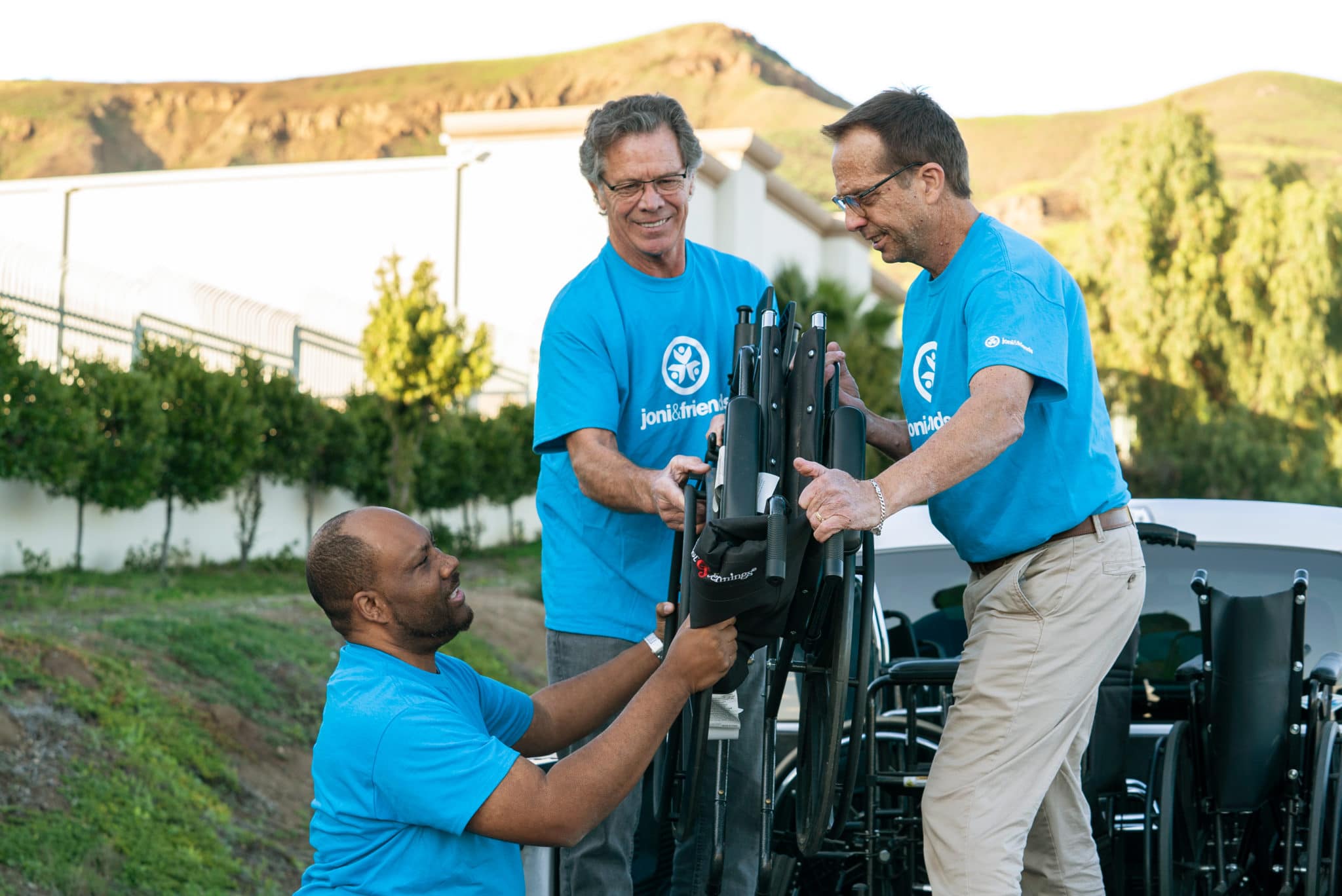 Volunteers collecting wheelchairs
