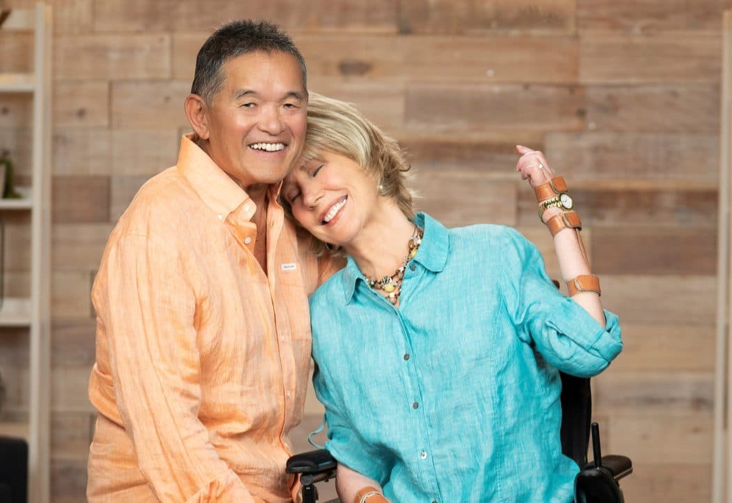 Joni resting her head po Ken's shoulder. 