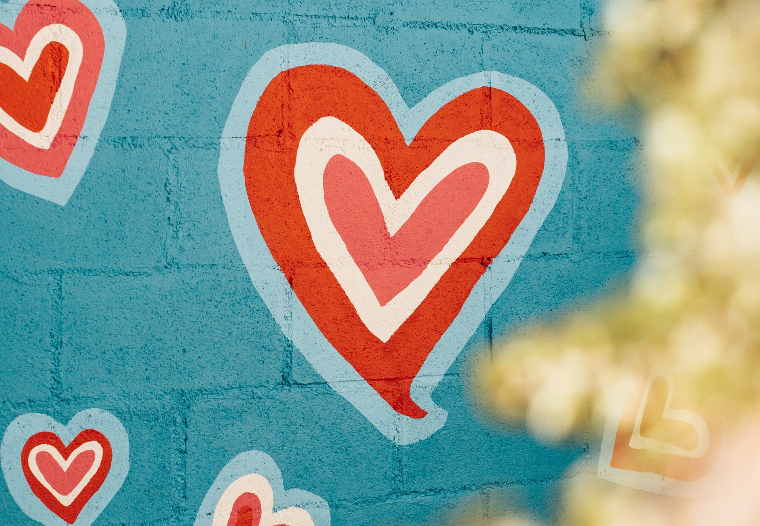 Close up of a multicolored heart painted on a wall.