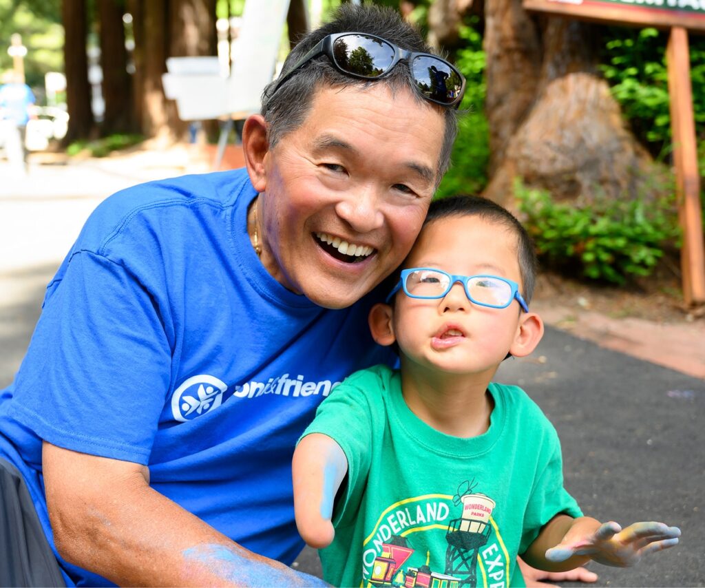 Ken Tada with a camper at Family Retreat