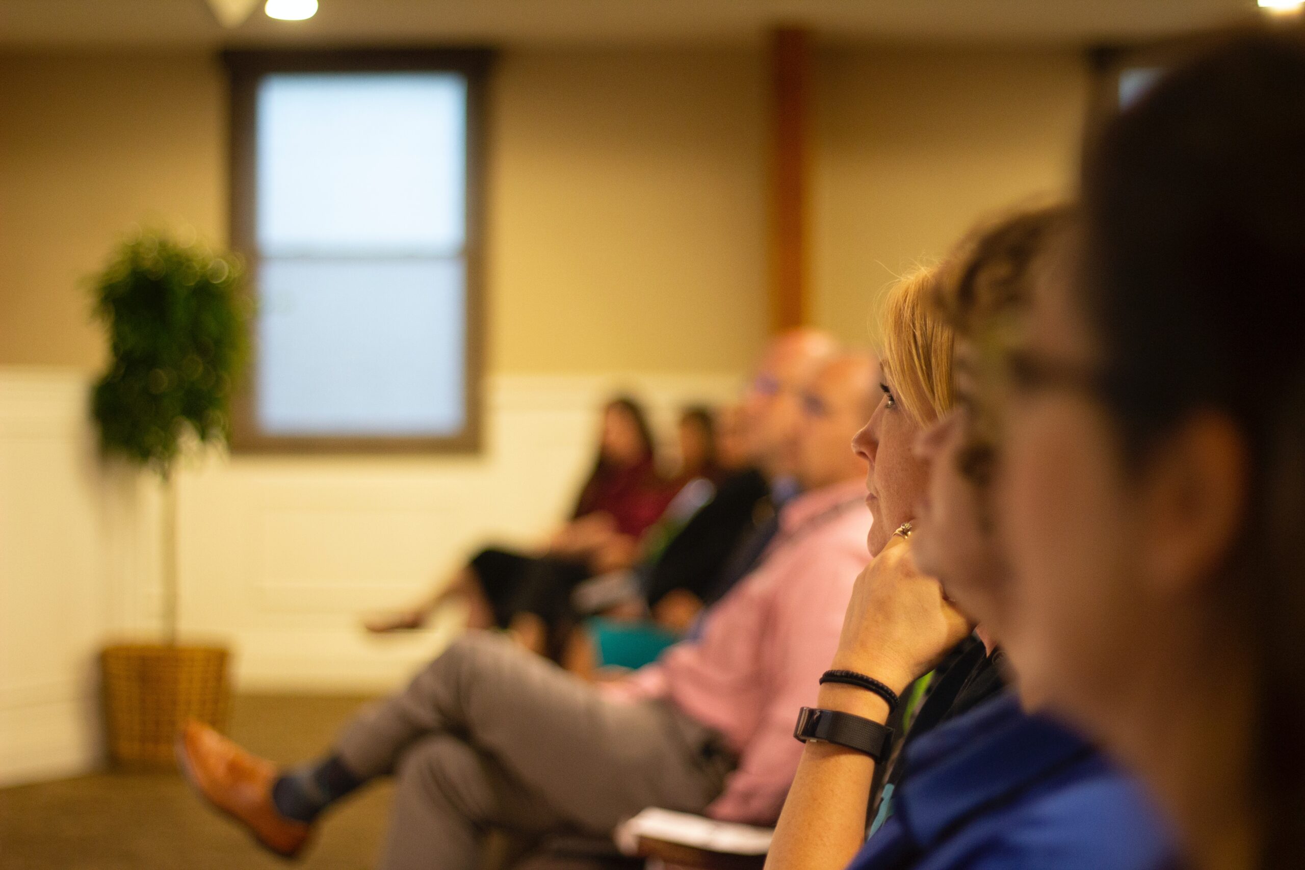 A close up of a row of parishoners in a church service.