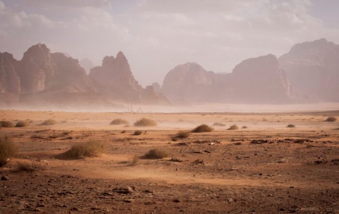 A picture of a desert landscape with rugged mountains in the distance.