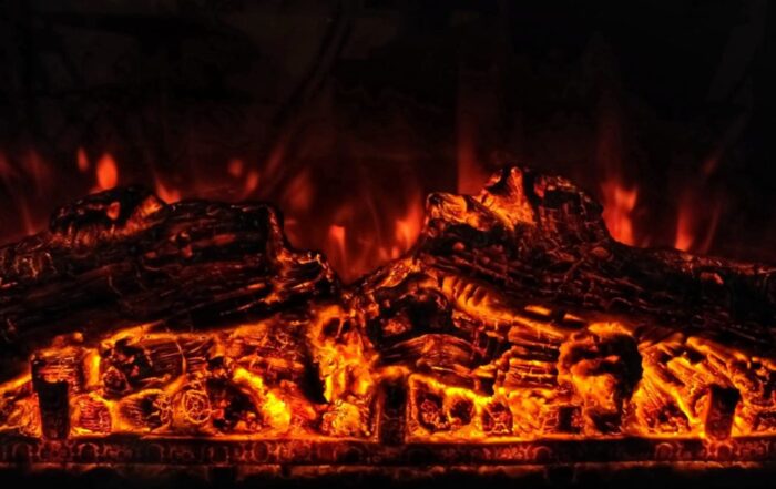 Close up of flaming logs in a fire pit.