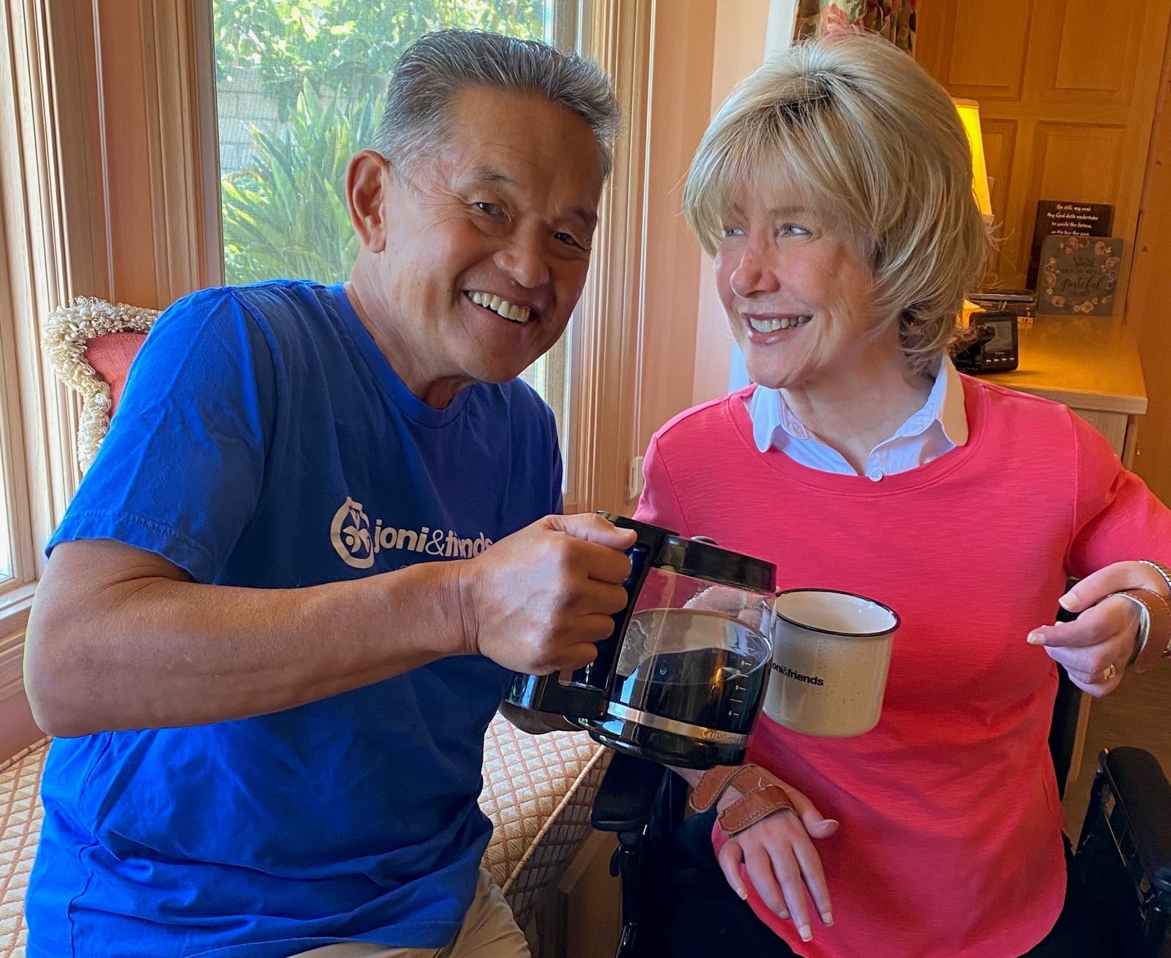 Close up of Joni smiling at Ken as he pours her a cup of coffee.