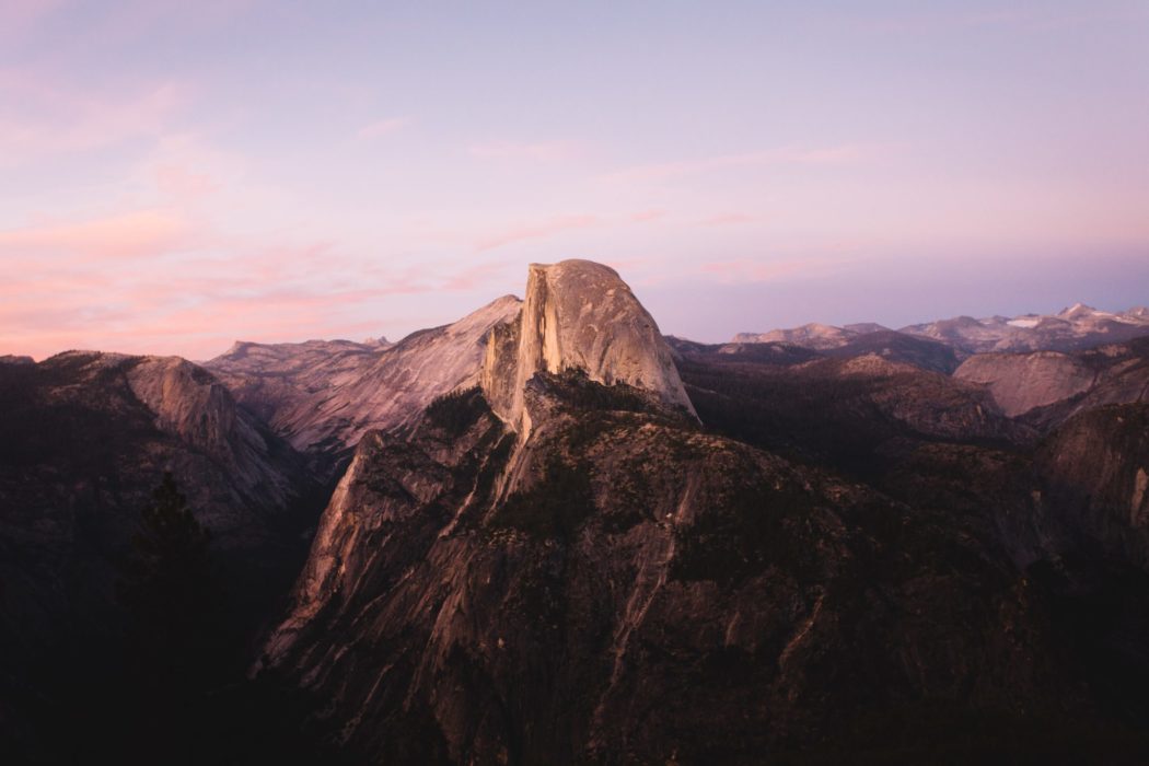 A mountain range set against a sunset sky.
