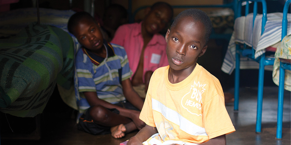 Three children with disabilities looking at the camera.