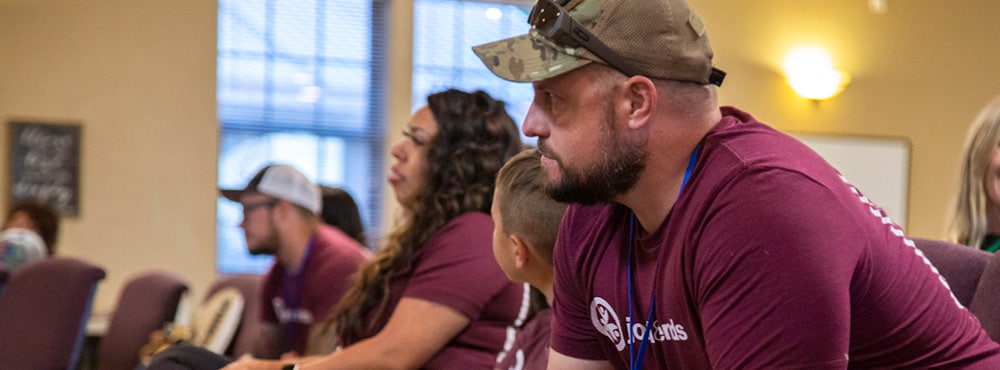 Veterans listen to a preacher at Warrior Getaway