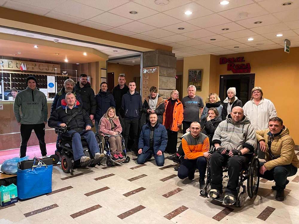 Ukrainian people of all abilities pose for a photo in a shelter