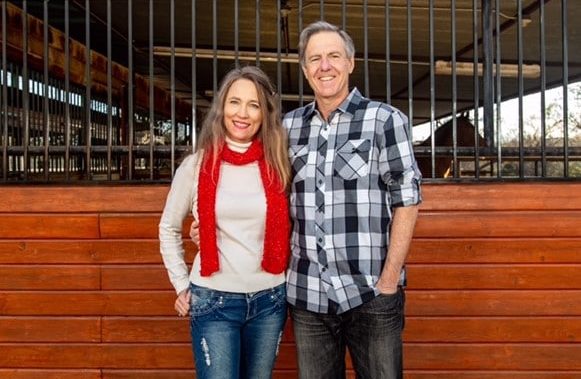 Dr. Andy Laurie with his arm around his his wife posing for a picture. Both are smiling.
