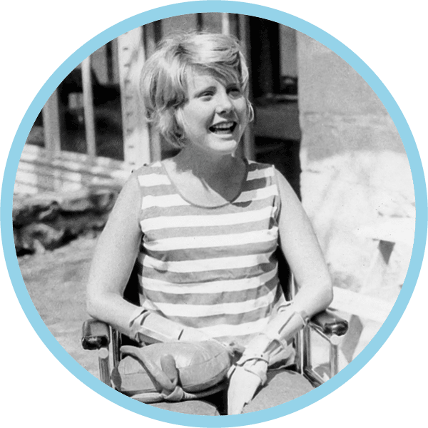 Young Joni Eareckson Tada sitting on her wheelchair.