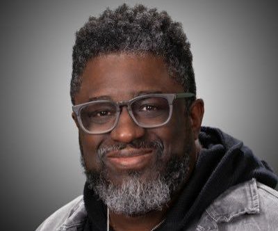 A close up portrait of Pastor Lamar Hardwick smiling at the camera.