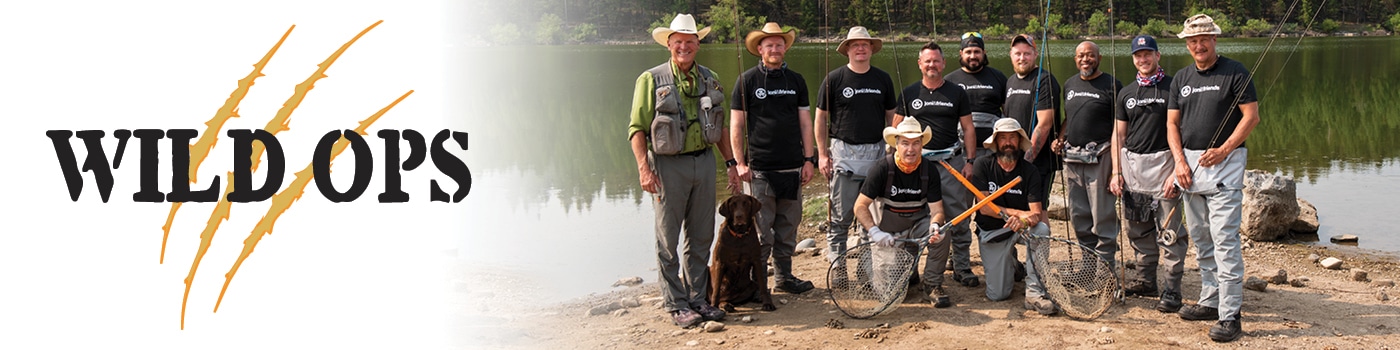 Wild Ops, a group of veterans stand with their fly fishing poles next to a lake
