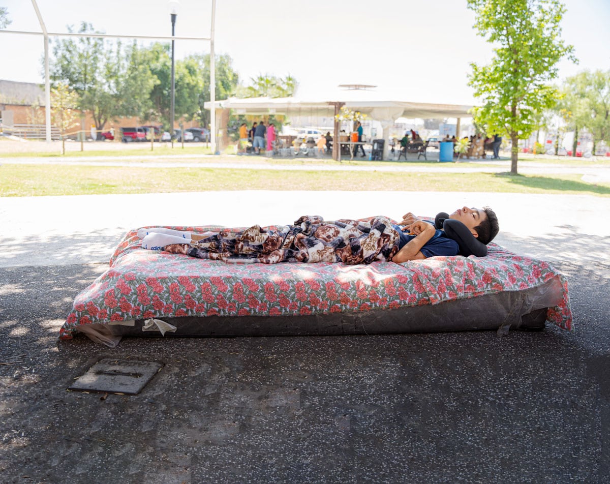 David laying on a mat with a floral sheet on it.