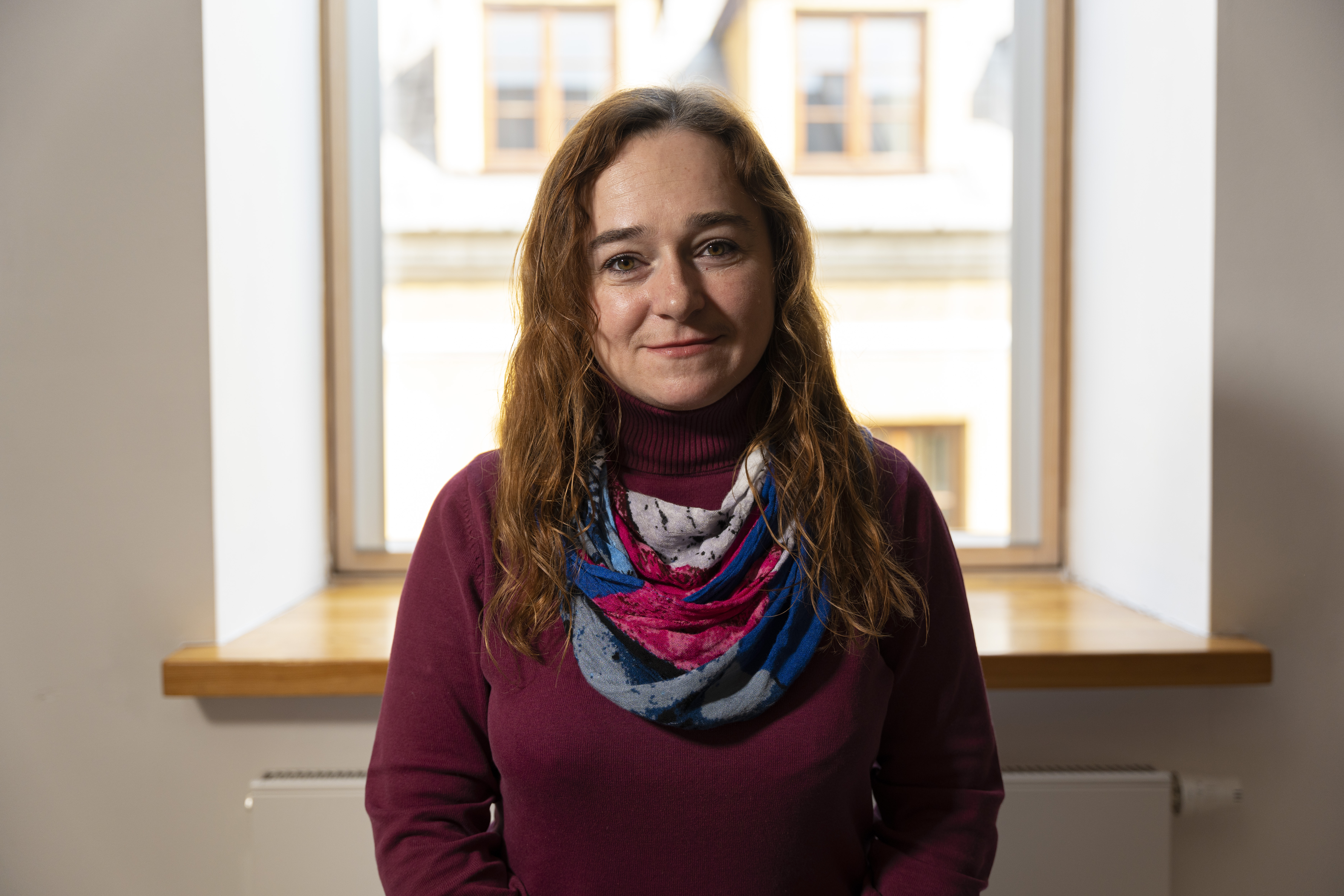 A close-up portrait of Galyna smiling at the camera.