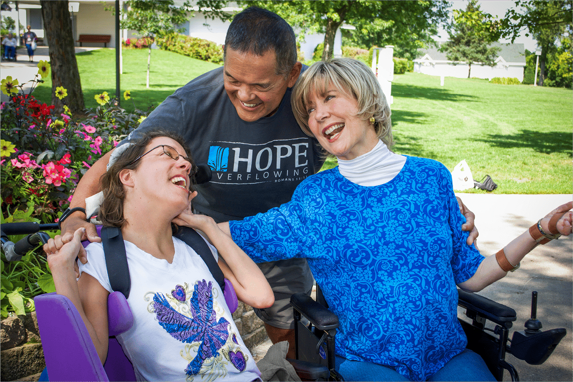 Joni and Ken smiling down at Vicki at Family Retreat.