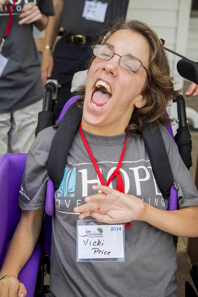 Vicki Price sitting in her purple chair smiling happily for the camera.