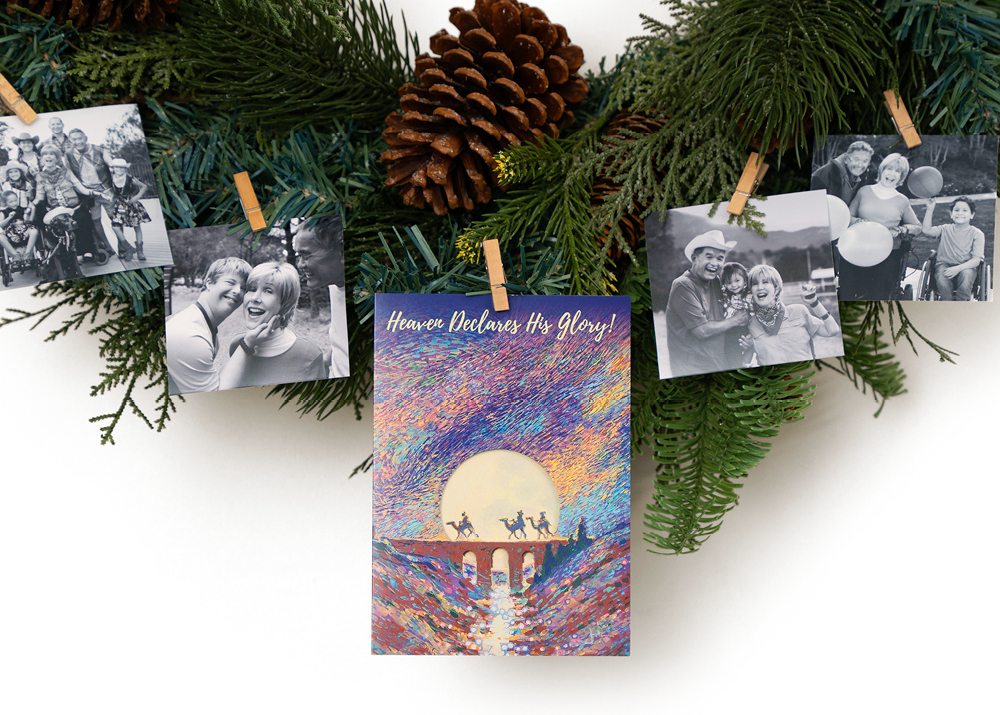 The Heaven Declares His Glory Christmas card haning from a reef along with ministry photos of Joni and Friends