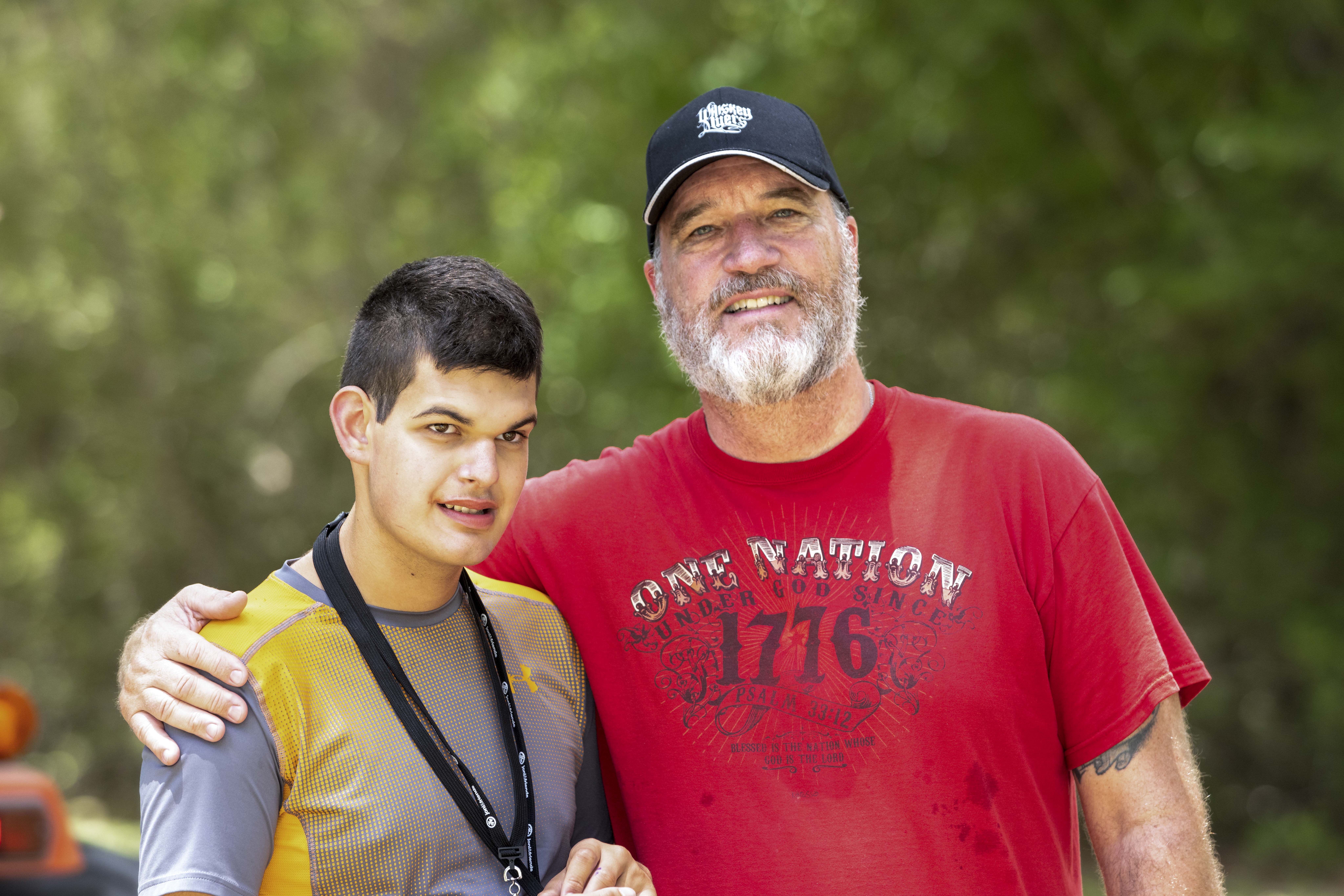 A picture of Isaac and another dad at family retreat.