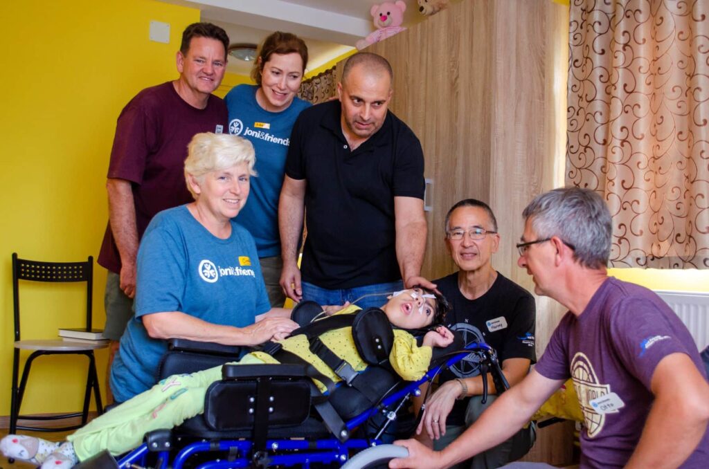 Maria in her new wheelchair with the Joni and Friends wheels for the world team around her.