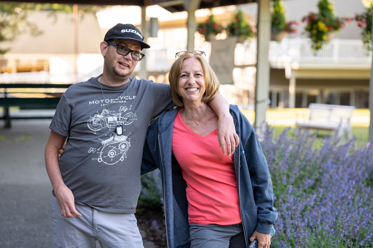 A picture of Dave and Judy, there arms around each other and smiling at the camera.