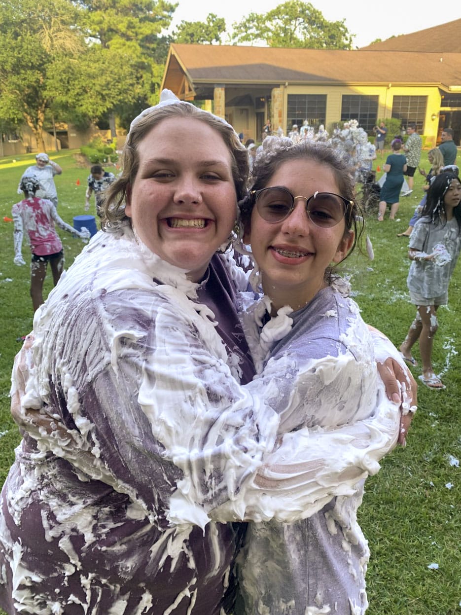 Libby smiling at the camera with a friend of hers from Joni and Friends camp.