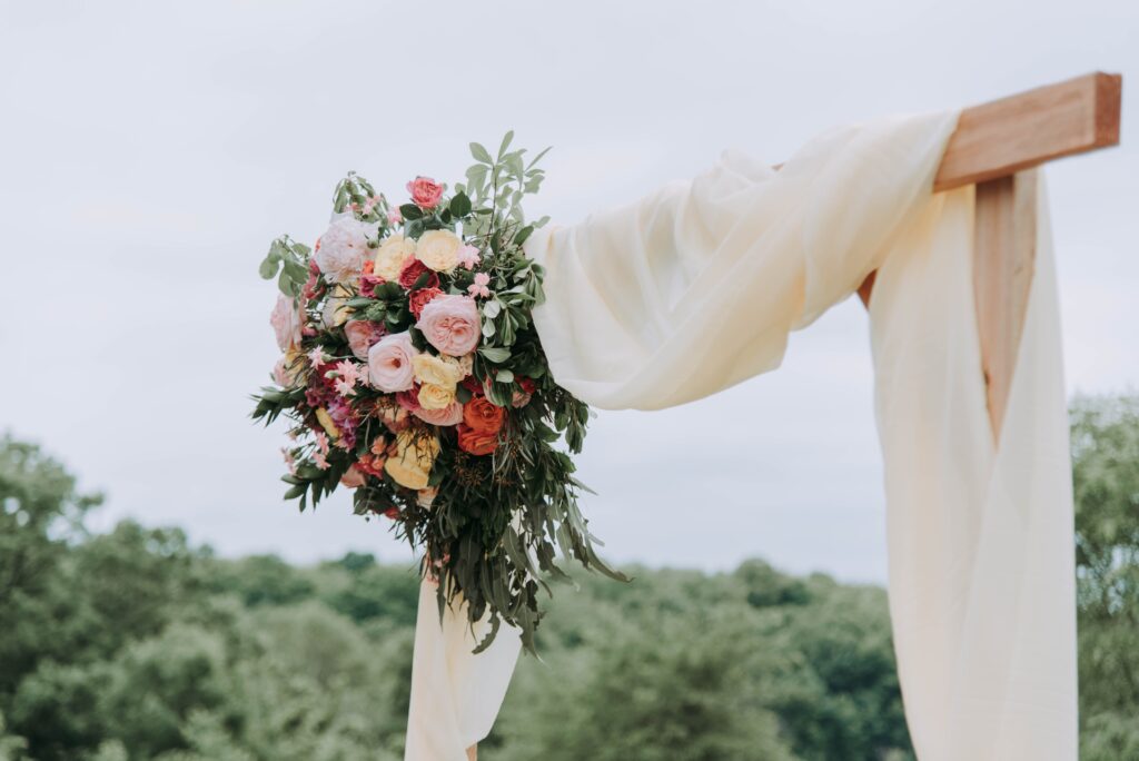 The view of a wedding Hoopa with a beautiful bouquet of multicolor flowers on it.