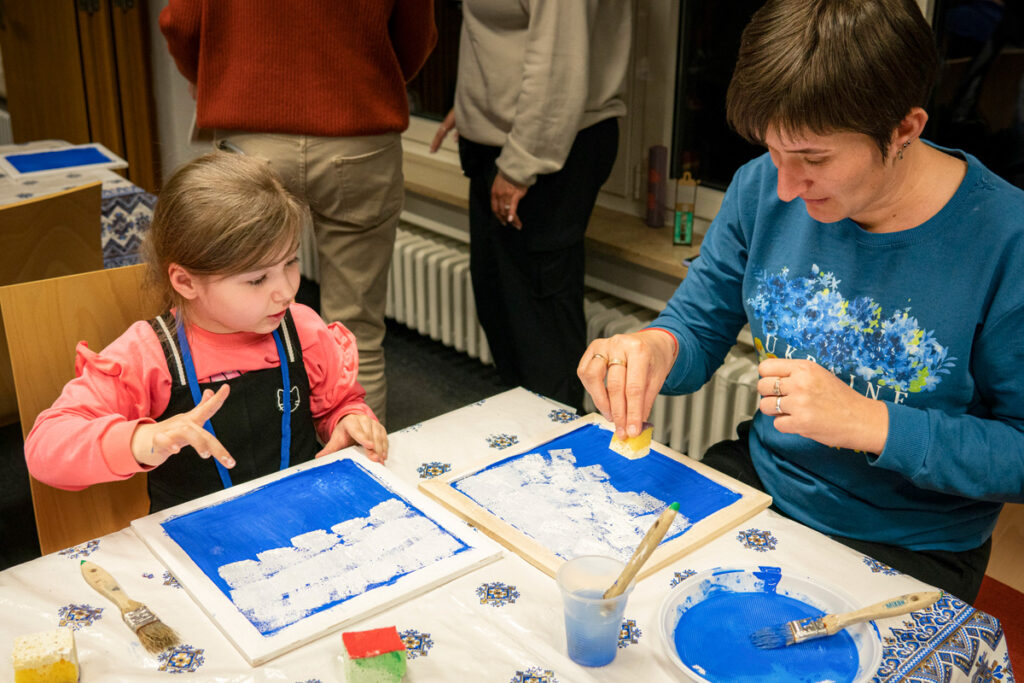 Irena and her daughter painting together.