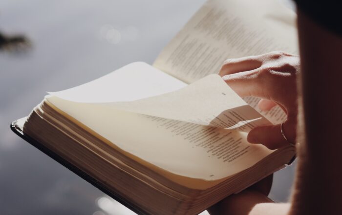 Close up of a man flipping through a bible.