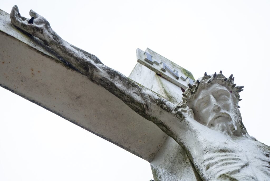 A statue of Jesus hanging on the cross with the crown of thorns on his head.