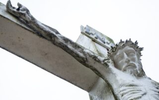 A statue of Jesus hanging on the cross with the crown of thorns on his head.