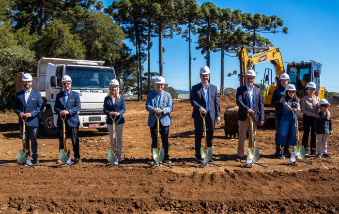 A group photo of Laura Gardner, Steve Bundy, Jason Holden and our Joni and Friends partners in Brazil holding shovels and wearing construction helmets.