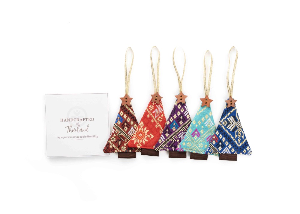 Christmas tree shaped ornaments in different colors with a note that reads "Handcrafted in Thailand by a person living with disability"
