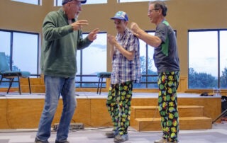 Jim, Ian and Ian's Joni and Friends buddy standing around and chatting. Jim and Ian are wearing matching Ninja Turtle pajama pants.