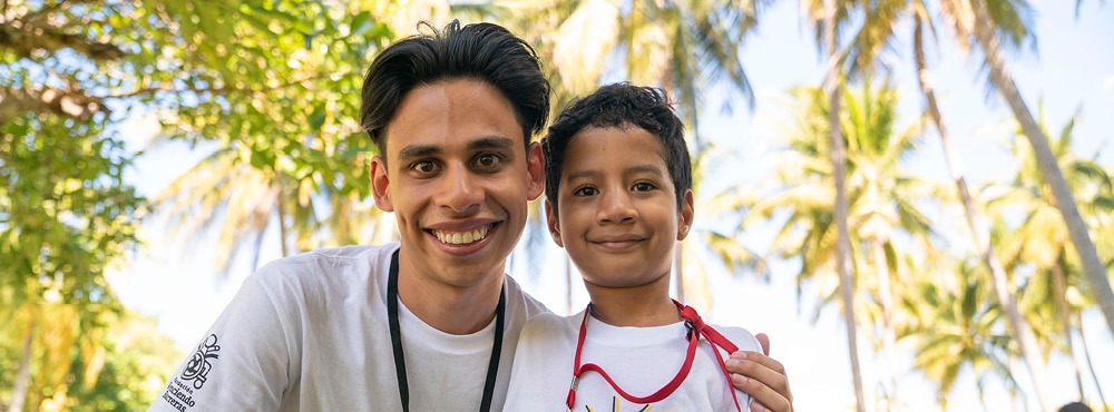 A man and a young boy posing for a photo.